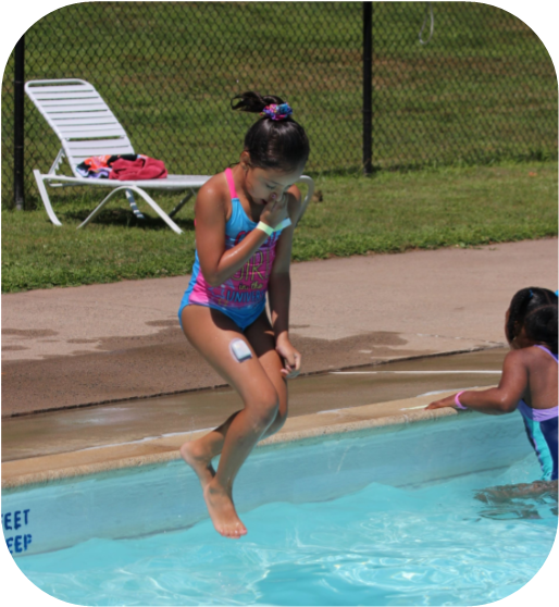 Girl jumping into Mountain Mist Day Camp pool at camp program for children with Type 1 diabetes