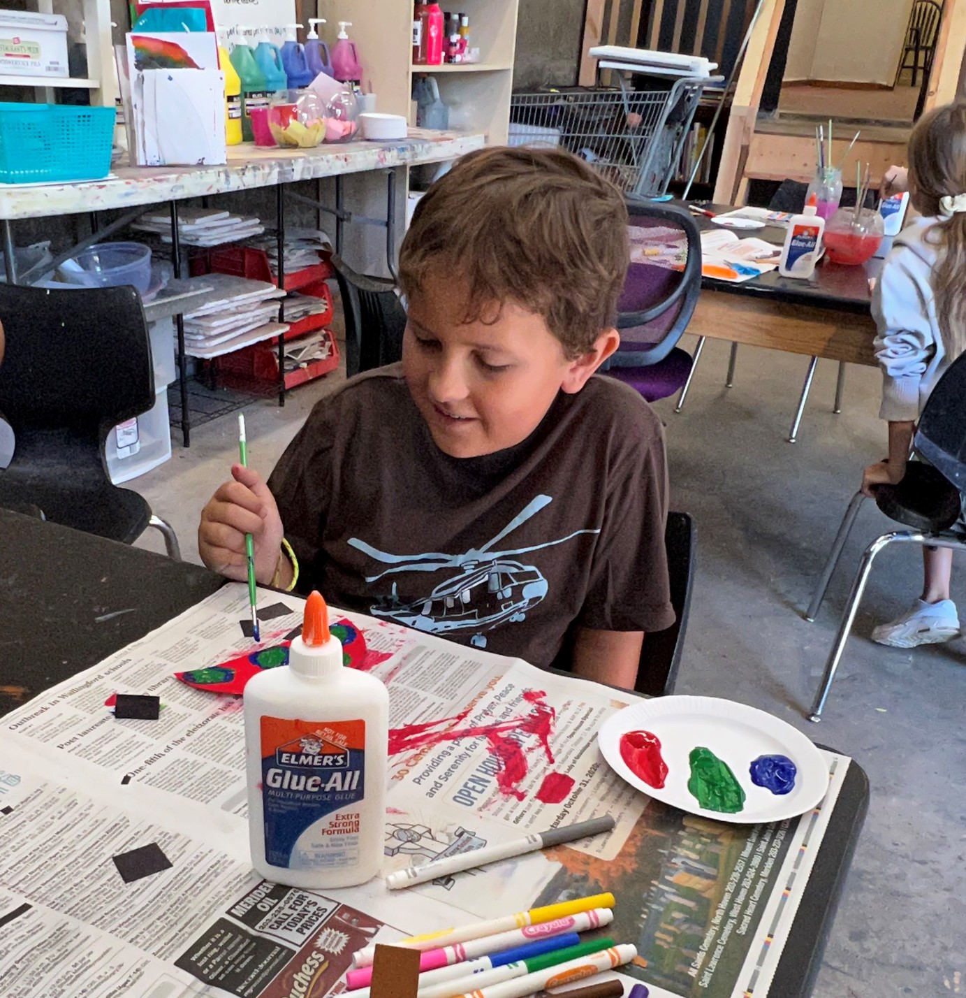 Boy creating art in Y Art Garage in Meriden