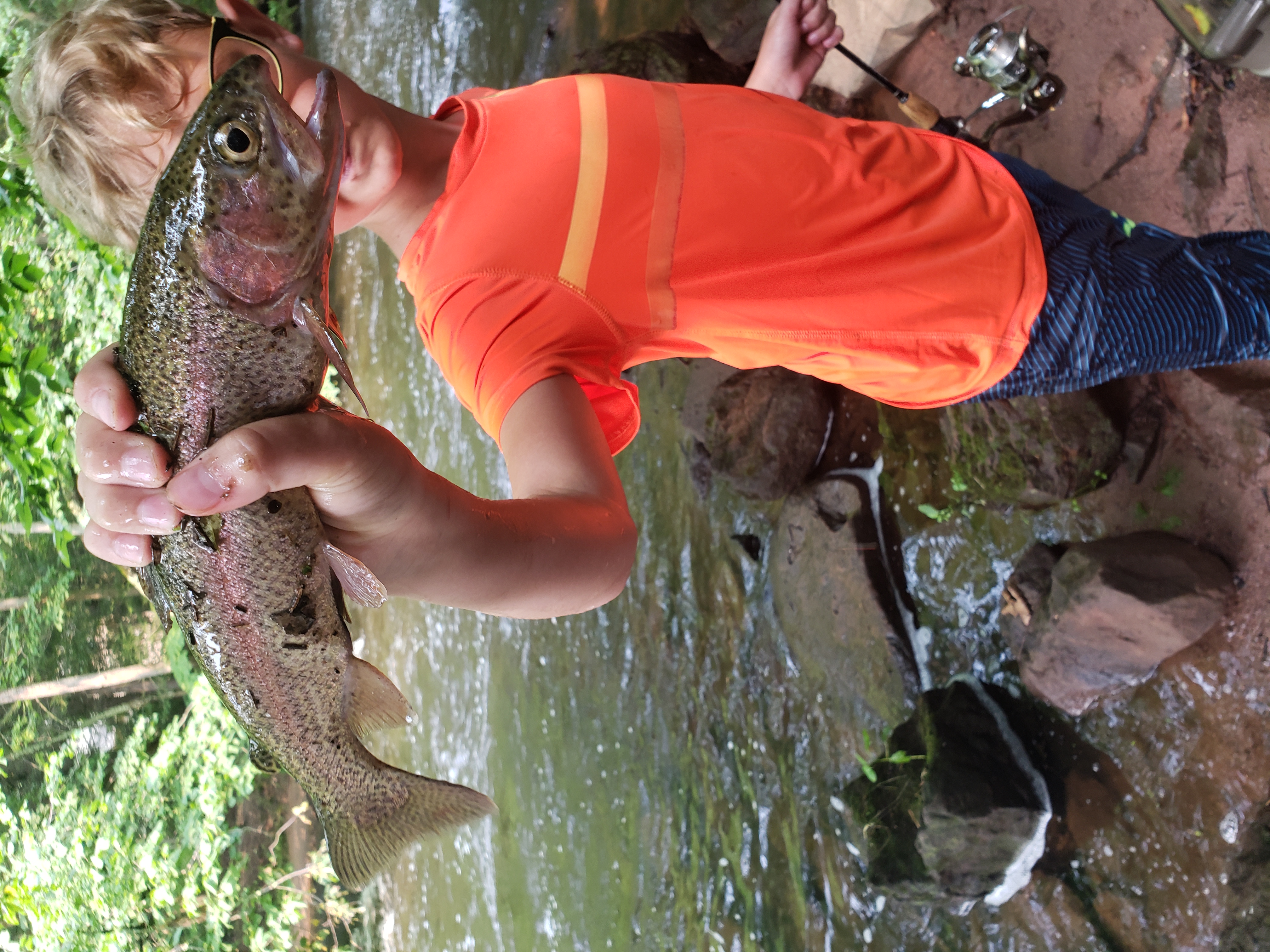 A boy at Mountain Mist Fishing Camp proudly showing the large fish he caught