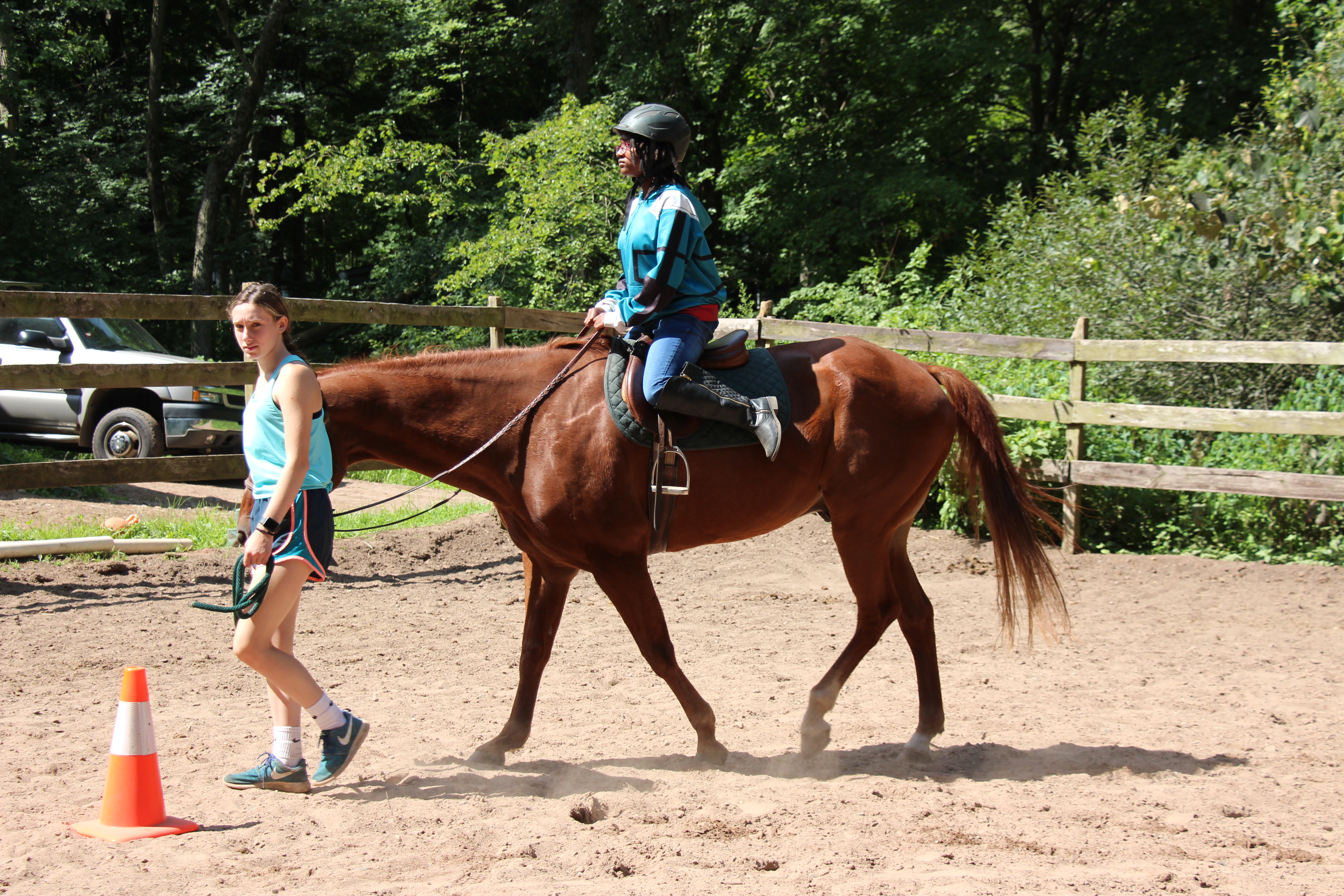 Girl learning to ride a horse at Mountain Mist Horseback Riding Camp 