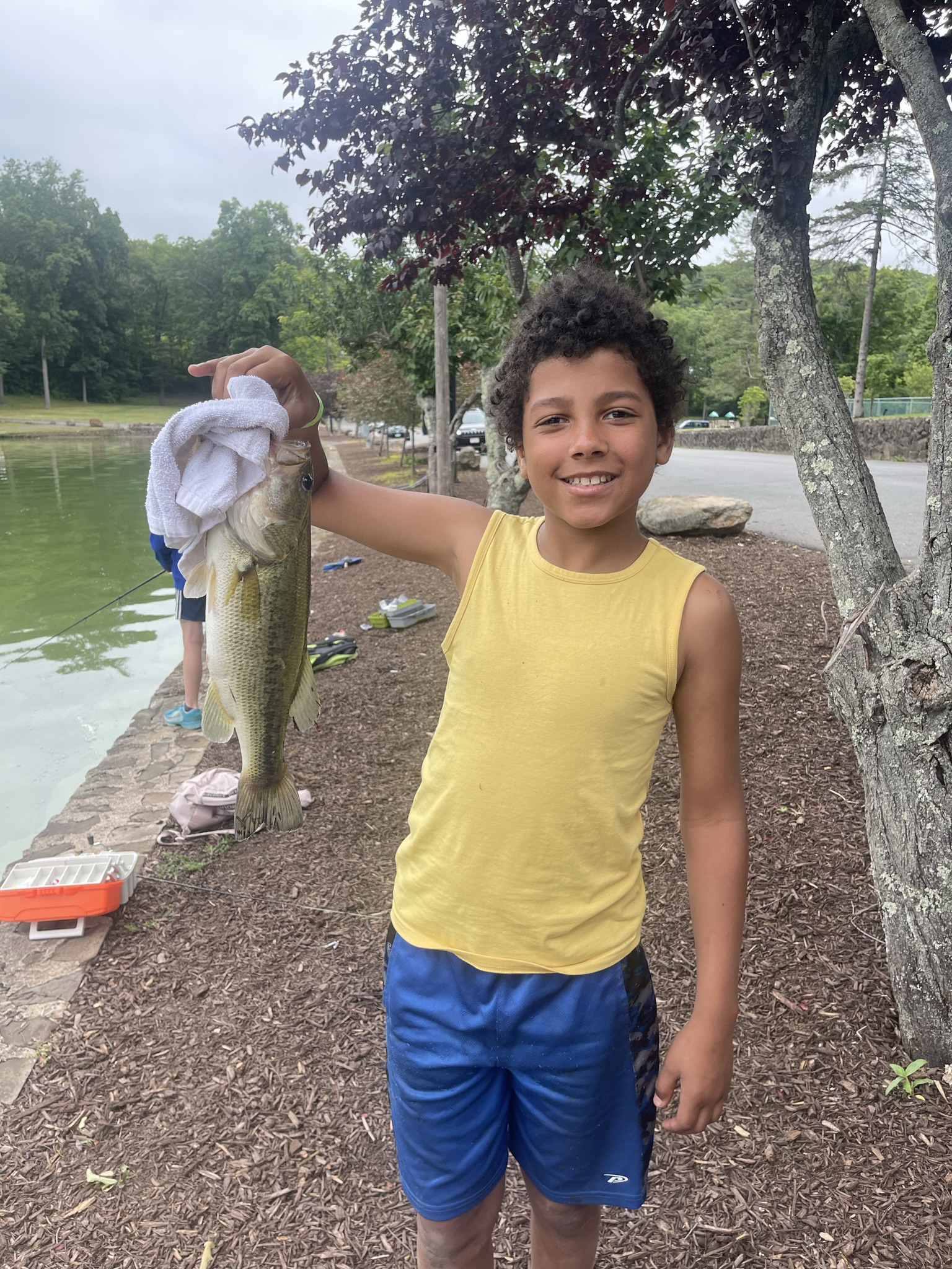 A boy at Mountain Mist Fishing Camp proudly showing the large fish he caught