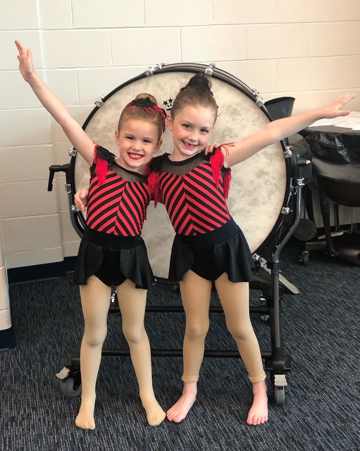 Two girls at dance recital standing in front of drum
